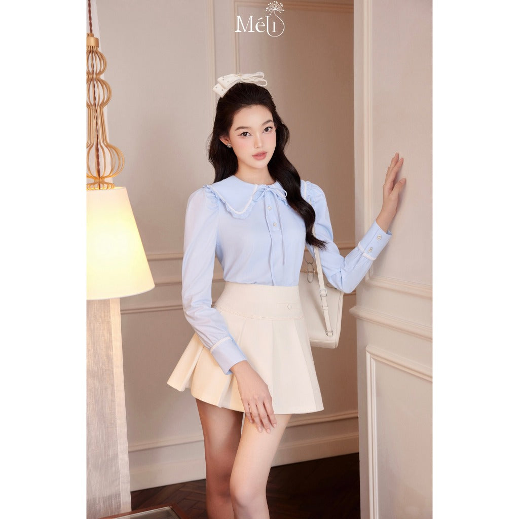 Blue long-sleeved ruffle collar shirt - Cream pleated skirt with cream lace - Méli