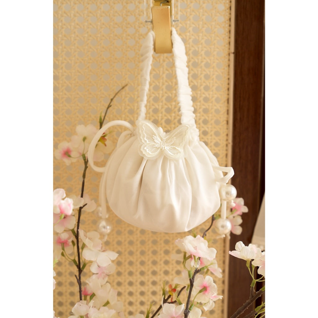 LA.NA brocade bag with innovative white design and luxurious drawstring floral pattern