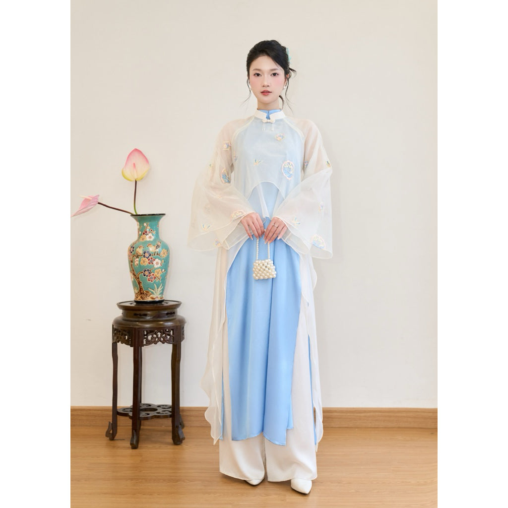The Trân Sắc-designed modernized silk ao dai features high-quality embroidered floral patterns, can be worn in two styles, and comes with a satin silk ruffled bodice – SD438 LANA DESIGN